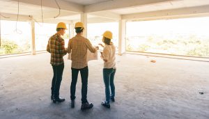 Officials reviewing construction plans on a newly built property