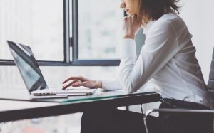 Woman applying for checking account on her computer