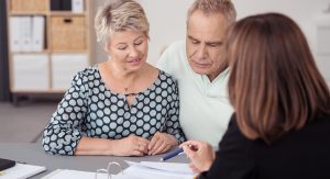 Middle-aged couple signing trust documents