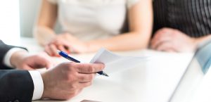 Couple signing trust paperwork
